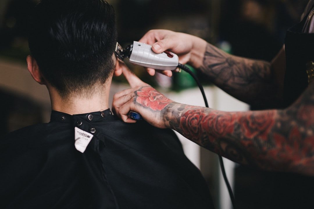Barbier rasiert mit einer Haarschneidemaschine den Nacken eines Mannes aus. | Foto: Hai Phung